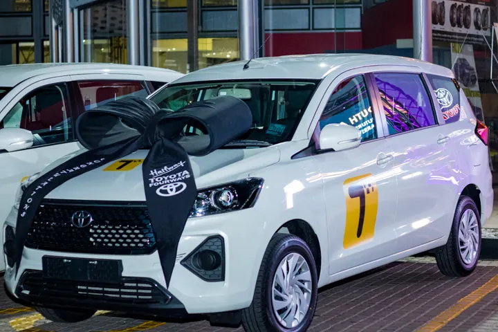 A white Teksi Ride car with the Teksi logo