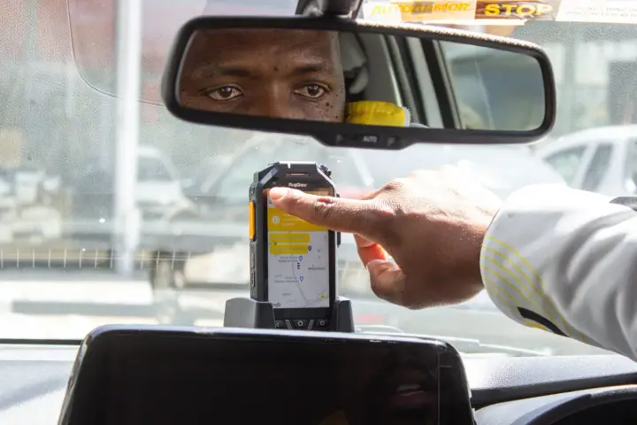 A Teksi driver using the in-car dispatch device